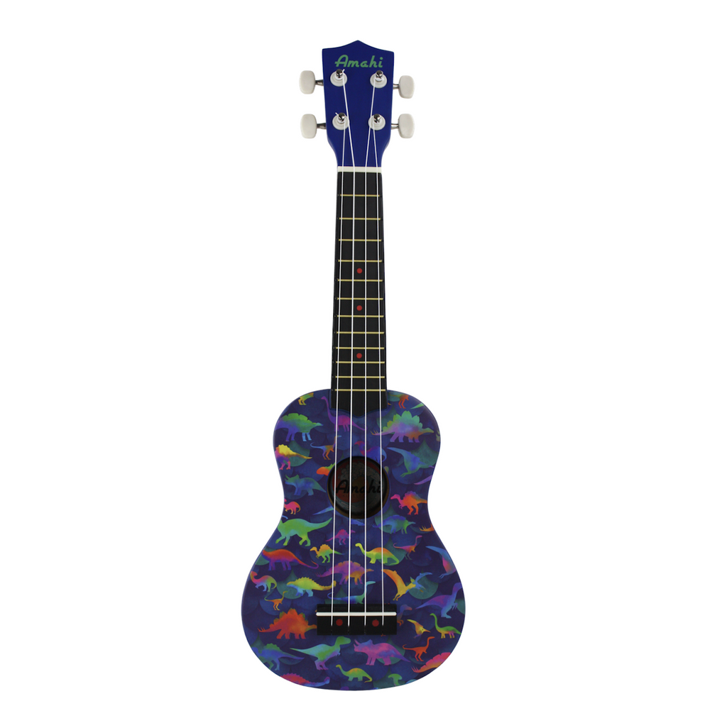Soprano sized ukulele with colorful dinosaurs covering the front of the wooden instrument body on a blue background. 