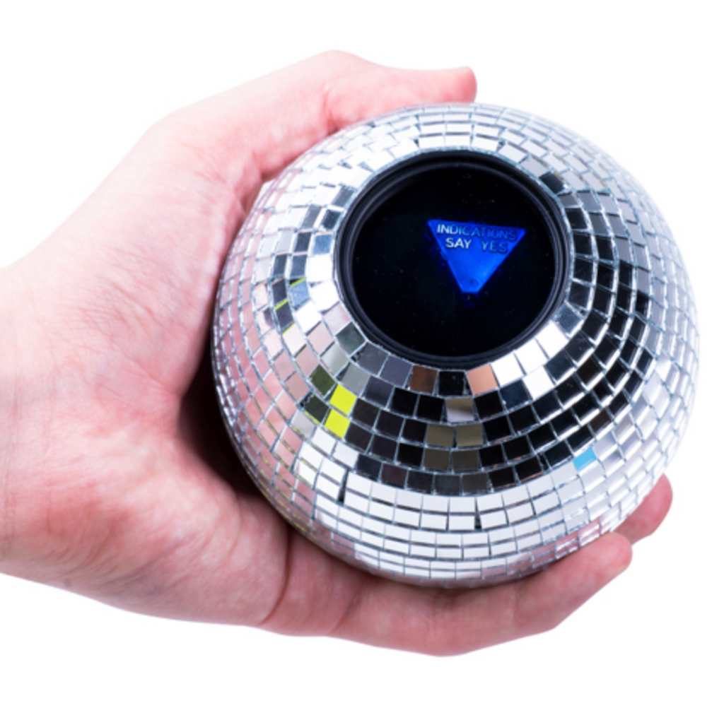 The Disco Decision Ball being held in a hand with an answer revealed that reads "Indications say yes" 