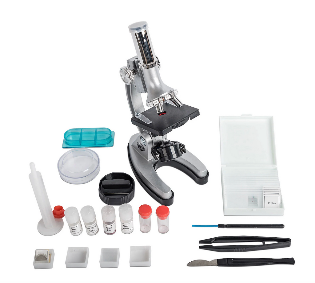 The microscope, slides, petri dish, specimen cups, and other tools that come with the Discovery Microscope Set with Case. 