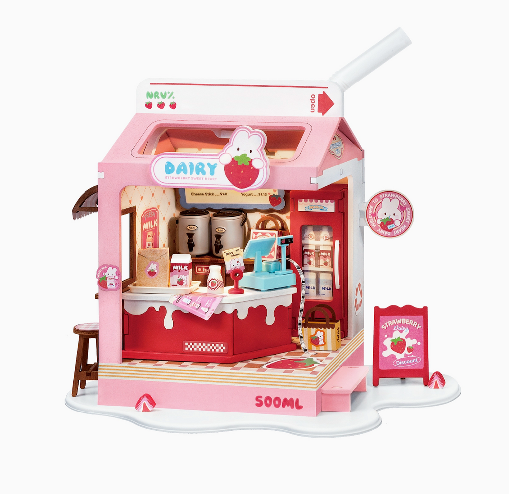 Close up picture of the Strawberry Milk Box DIY Miniature Box model set up for display with all of the accessories included in the set. 