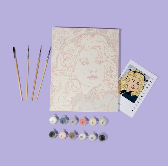 The preprinted canvas, paints and paint brushes included with the Dolly Parton Paint by Number Kit. 