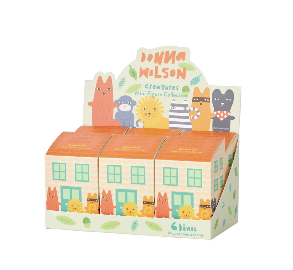The Donna WIlson Creature Series blind box mini figures packaged in cottage shaped boxes.