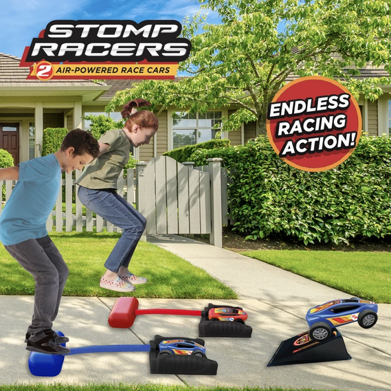 Dueling Stomp Racers set up on the sidewalk and two kids launching them to race. 