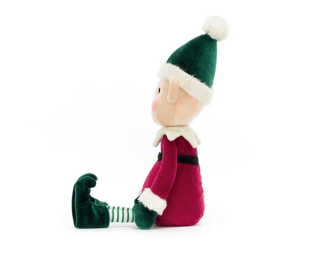 Plush toy elf with green hat and red outfit on a white background