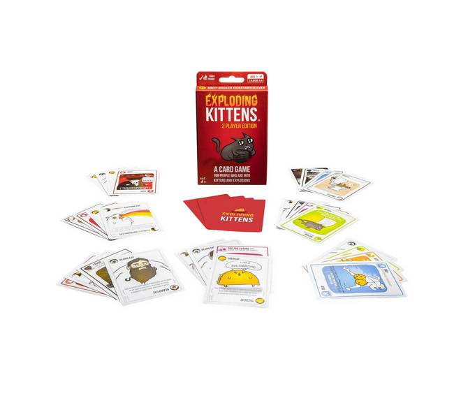 The box for Exploding Kittens 2 Player Edition with cards set up around it, ready to play the game. 