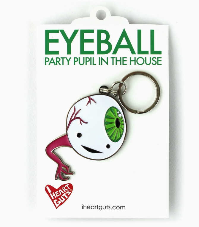 Enamel Eyeball keychain packaged on a white backing card with green lettering that reads "Eyeball Party Pupil In The House"