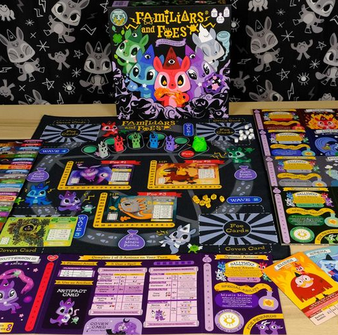 The Familiars and Foes board game set up for play, with game pieces and cards used in play. 