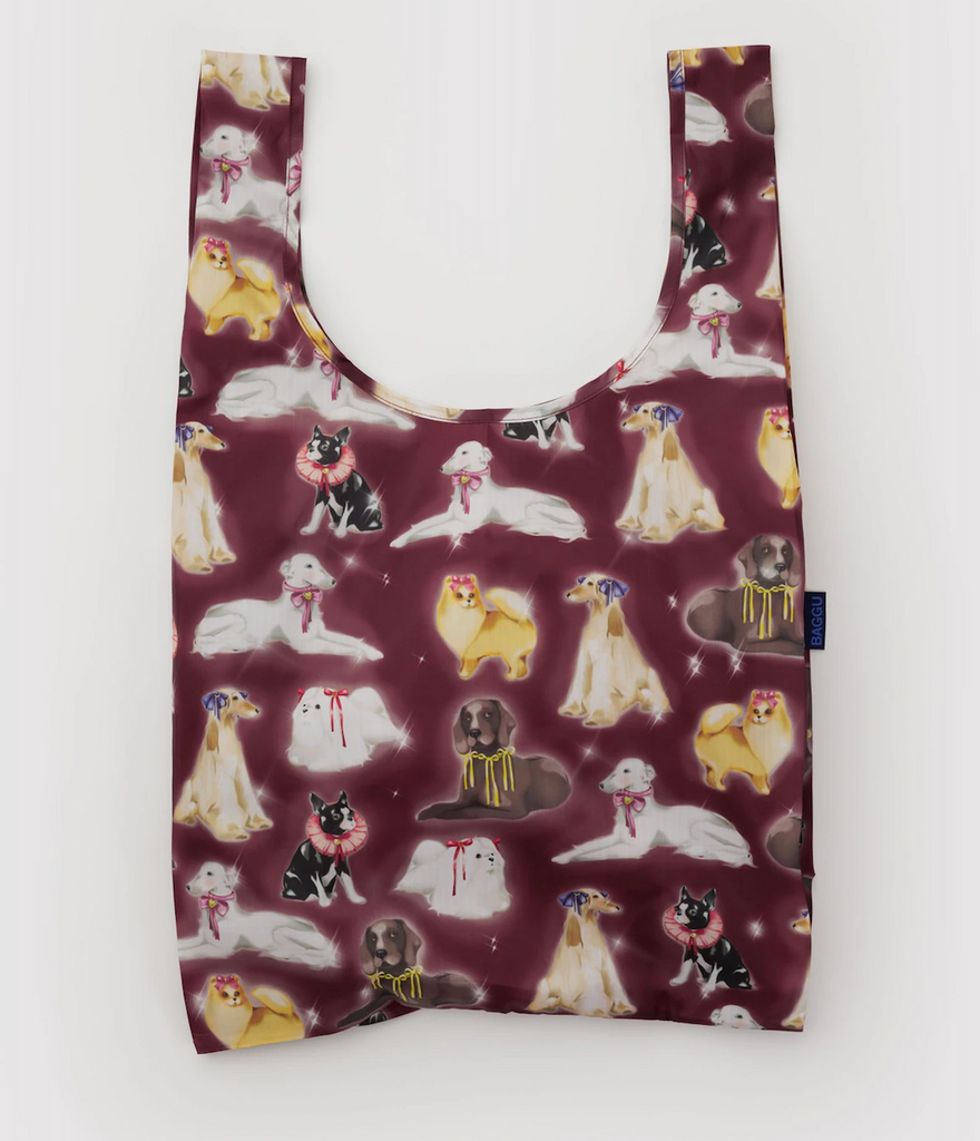 Reusable Baggu shopping bag with a fancy dog pattern on a burgundy background. 