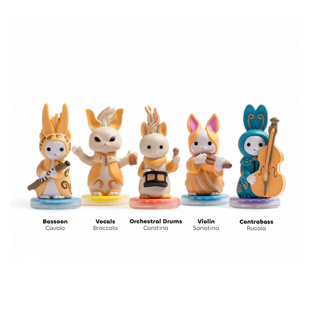 Five small rabbit-like figurines from the Fantasimo Classical band, each holding a different instrument and standing on colored circular bases. Including Bassoon Cavalo, Vocals Broccoli, Orchestral Drums Caratna, Violin Sonatina, and Contrabass Rucola.