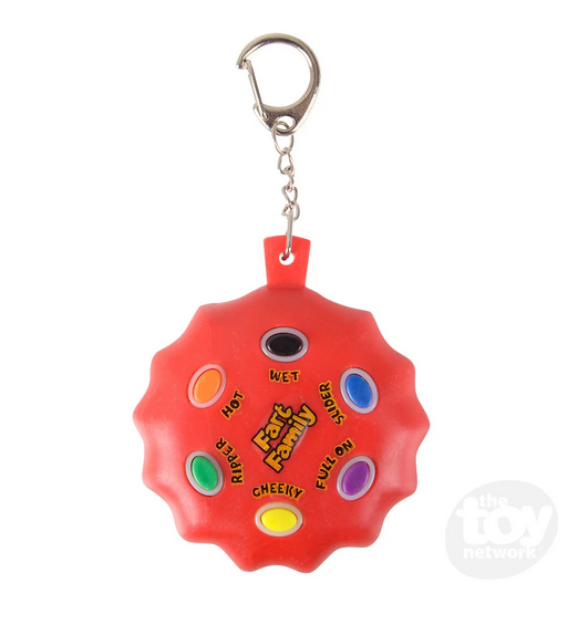 Close up of the Farting Sound Keychain which is round, red and has color coded buttons for various fart sounds. 