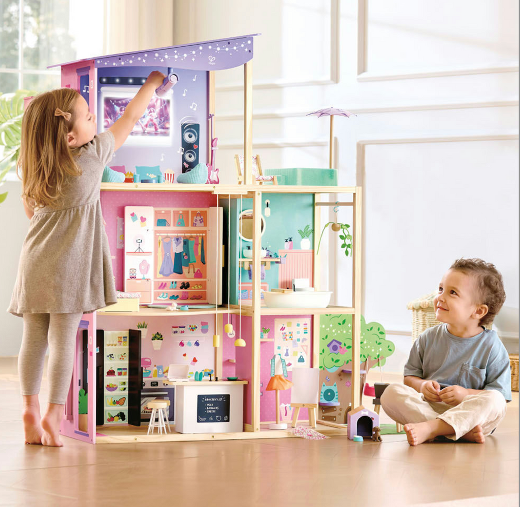 Two toddler aged children playing with the Fashion Glow Dream Mansion 