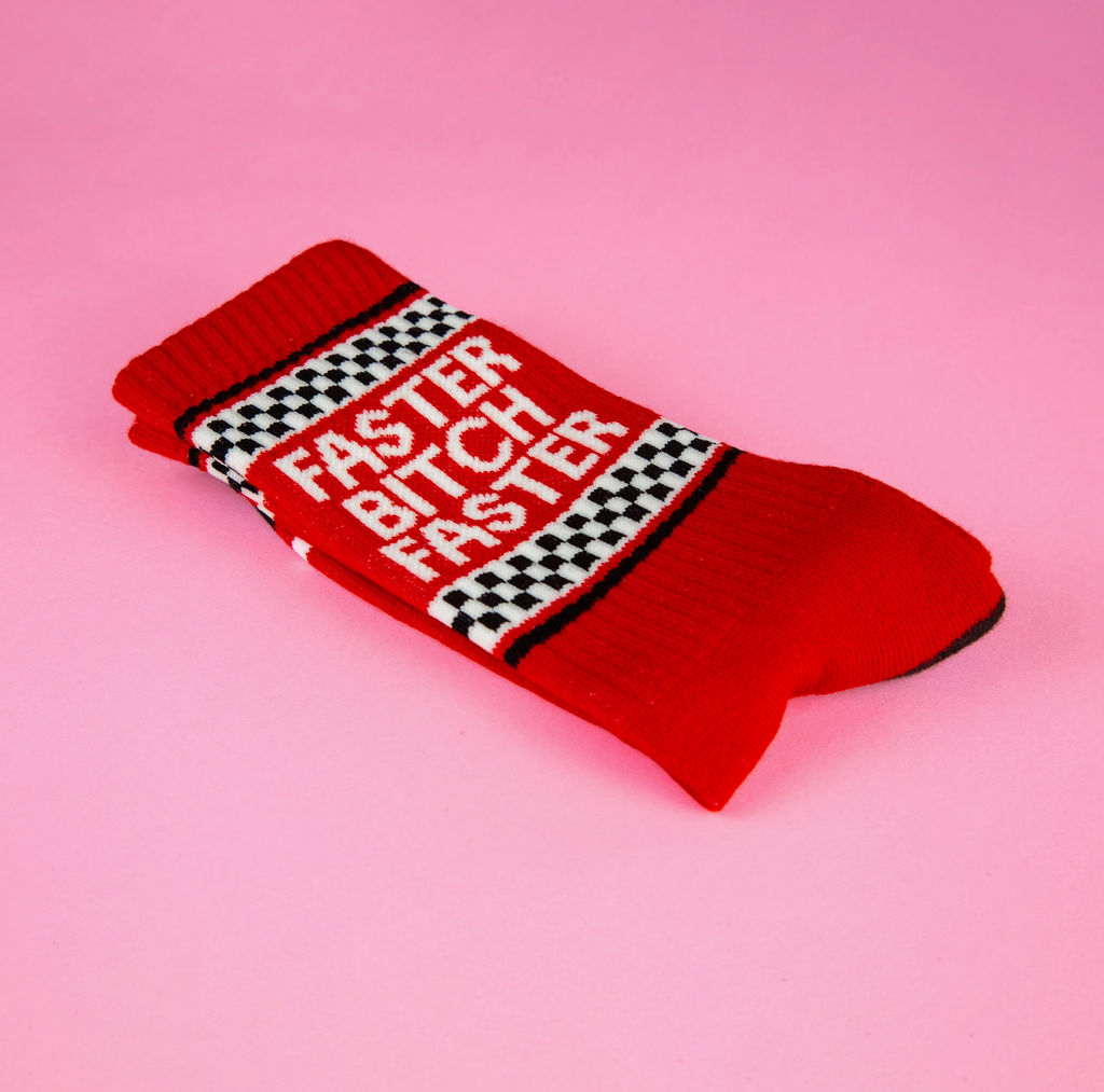 Red tube socks with black and white checkerboard pattern at the top that read "Faster Bitch Faster" in white letters. 