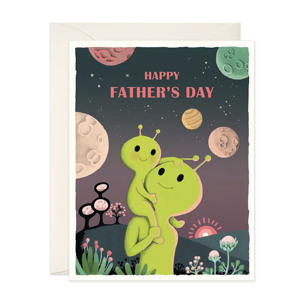 Illustrated cover of the Father's Day Aliens greeting card, with an illustration of a cartoon alien dad holding a child alien on its shoulder with text that reads 'Happy Father's Day'