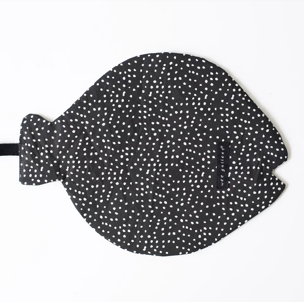 The backside of the Fish Crinkle Toy, a fish shaped piece of fabric that makes a crinkle noise and has white polka dots on a black background. 