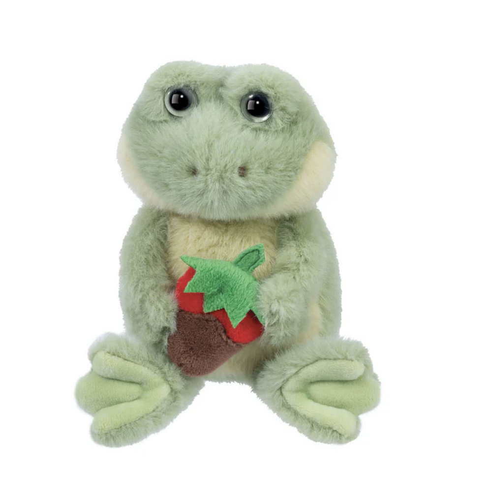 Green plush stuffed frog holding a chocolate covered strawberry in a seated position. 