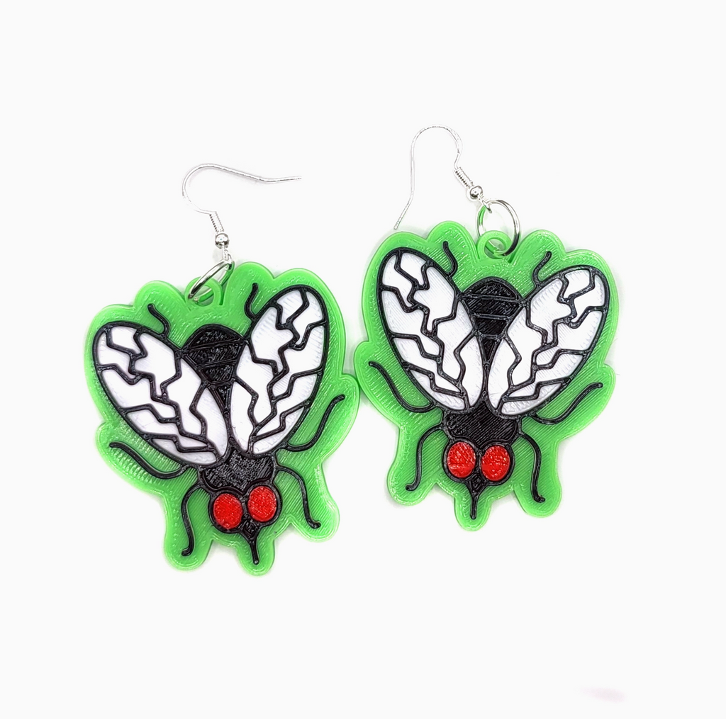 Close up view of the 3D printed fly earrings with silver plated ear wire. 