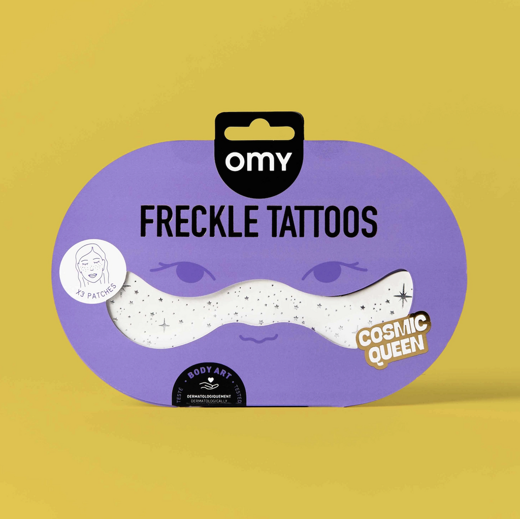 Package of Freckle Tattoos Cosmic Queen in a purple envelope with an opening that shows the star shaped freckle temporary tattoos. 