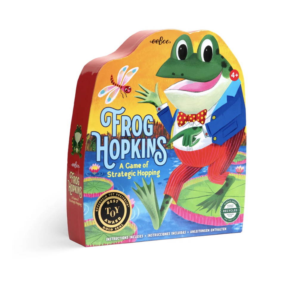 Shaped box with a bright and colorful illustration of Frog Hopkins a frog wearing a suit with a red and yellow polka dot bow tie hopping along lily pads in a pond. 