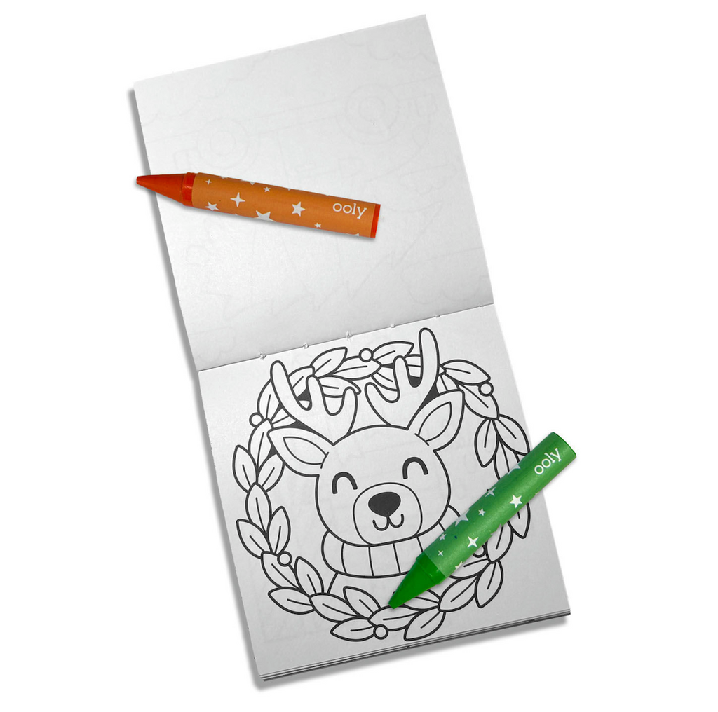 Interior coloring page of a reindeer wearing a sweater inside a wreath, with green and red crayons. 