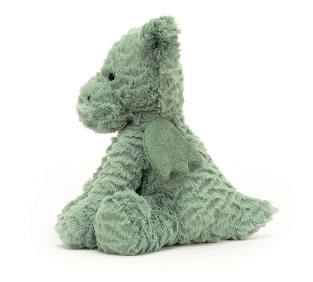 Green plush dragon toy on a white background