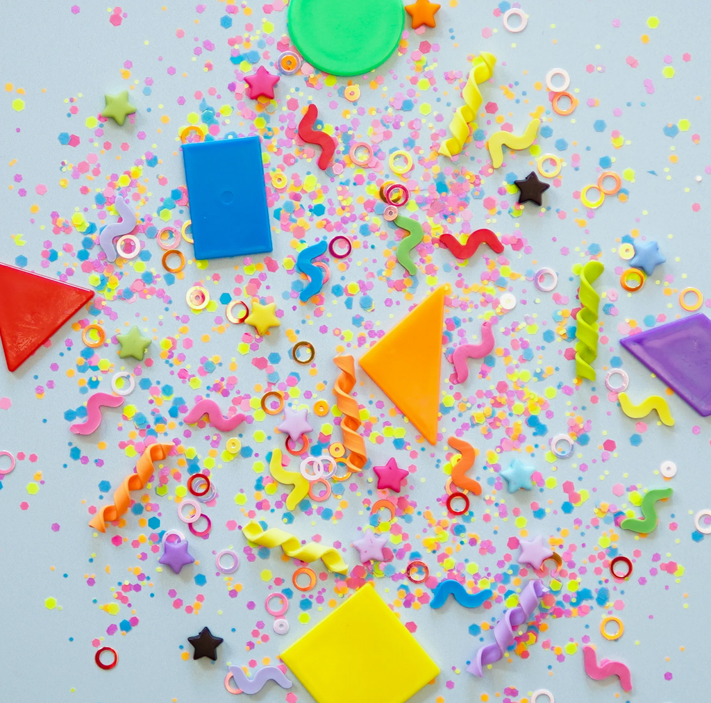 Fun Filler Shapes on a grey background. Shapes include triangles, rectangles, twists, squiggles, rings, confetti, and sequins in bright colors.