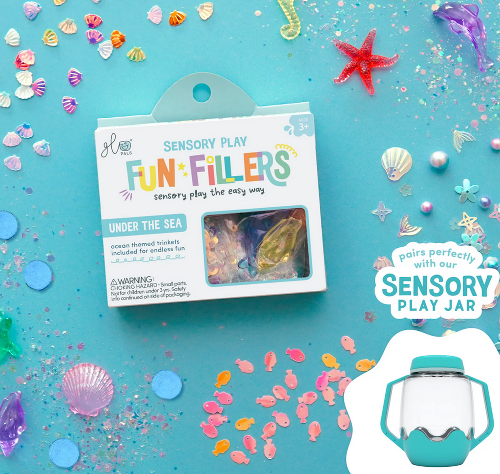 Seashells, fish, starfish and colorful glitter from the Under the Sea Fun Filler trinket package. 