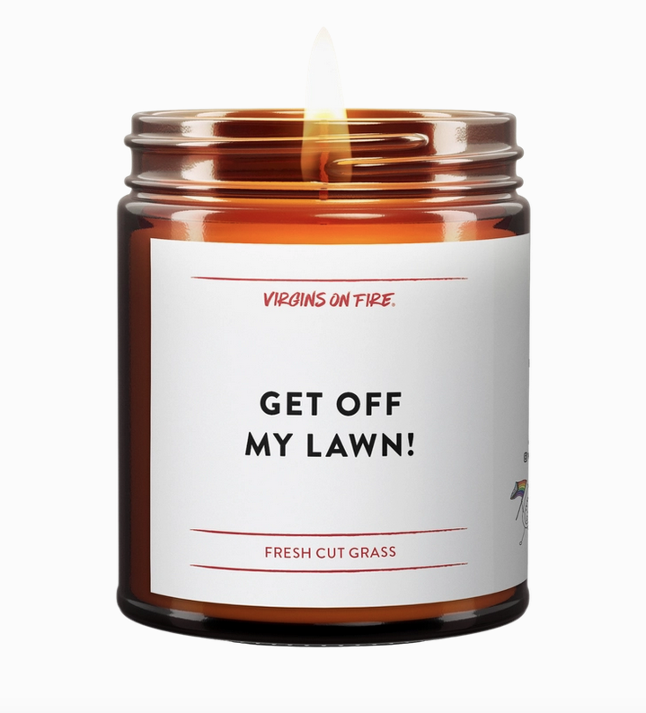 Get Off My Lawn candle in brown glass jar with white label with black lettering.