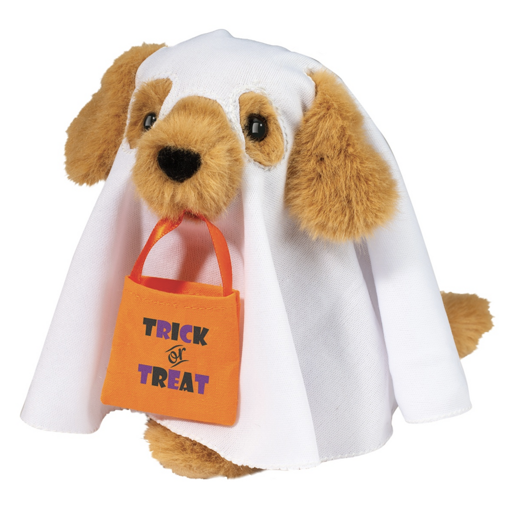 Golden retriever dog wearing a white sheet and carrying an orange trick or treat bag stuffed animal.