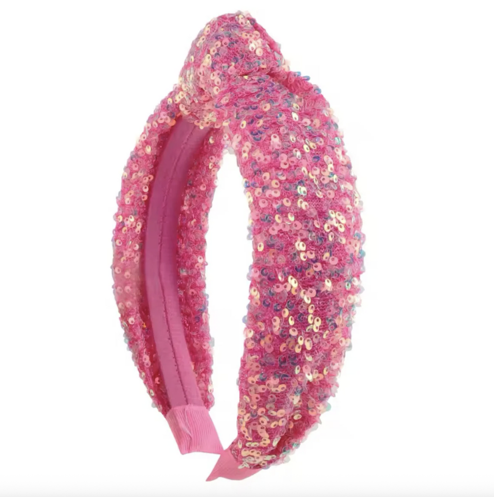 Bright pink sequined headband viewed from the side. 