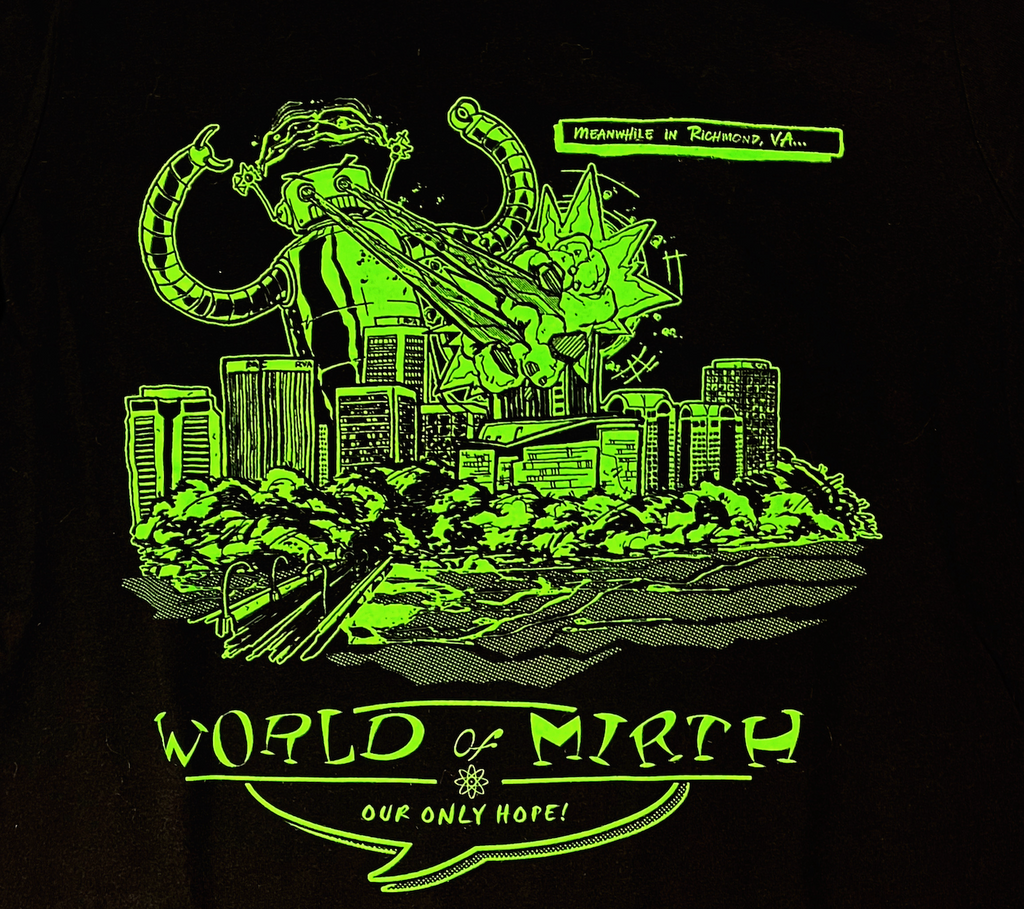 Close up of the World of Mirth glow in the dark green t-shirt. 