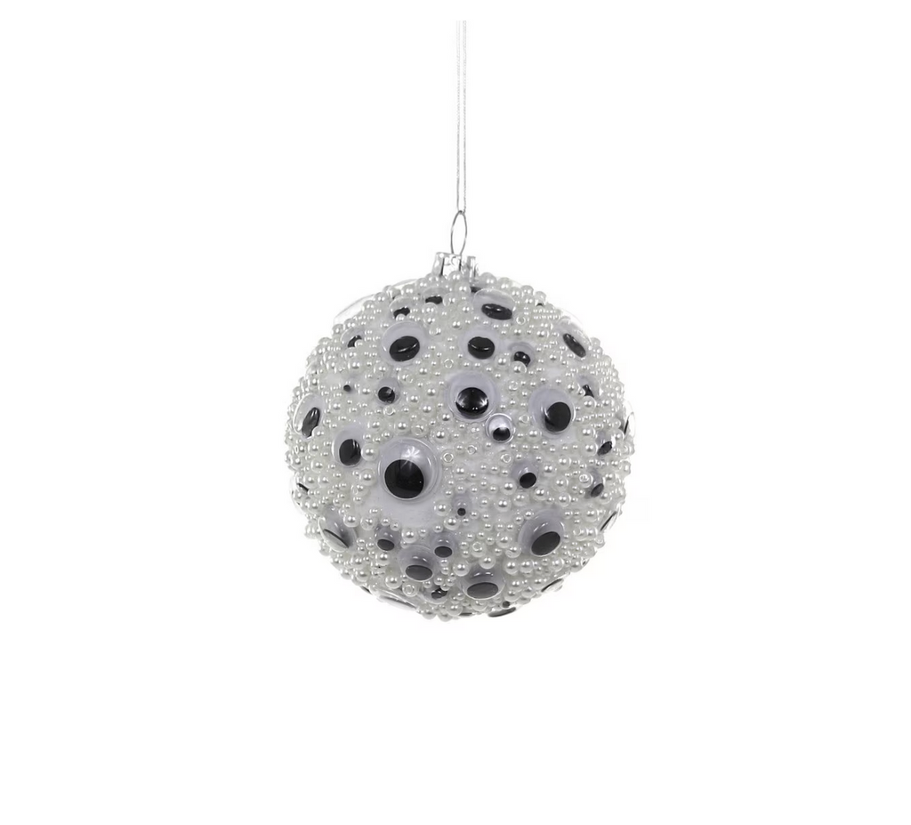 Round white beaded ornament with googly eyes all over.