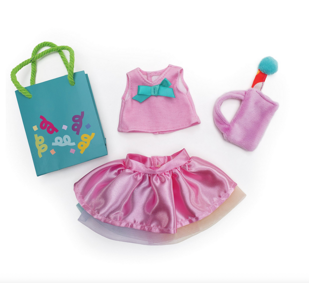 Groovy Girls Party Perfect clothing set including a pink top with a bow, satin skirt with tulle trim, a purse with a decorative soft boa ball, and a paper gift bag.