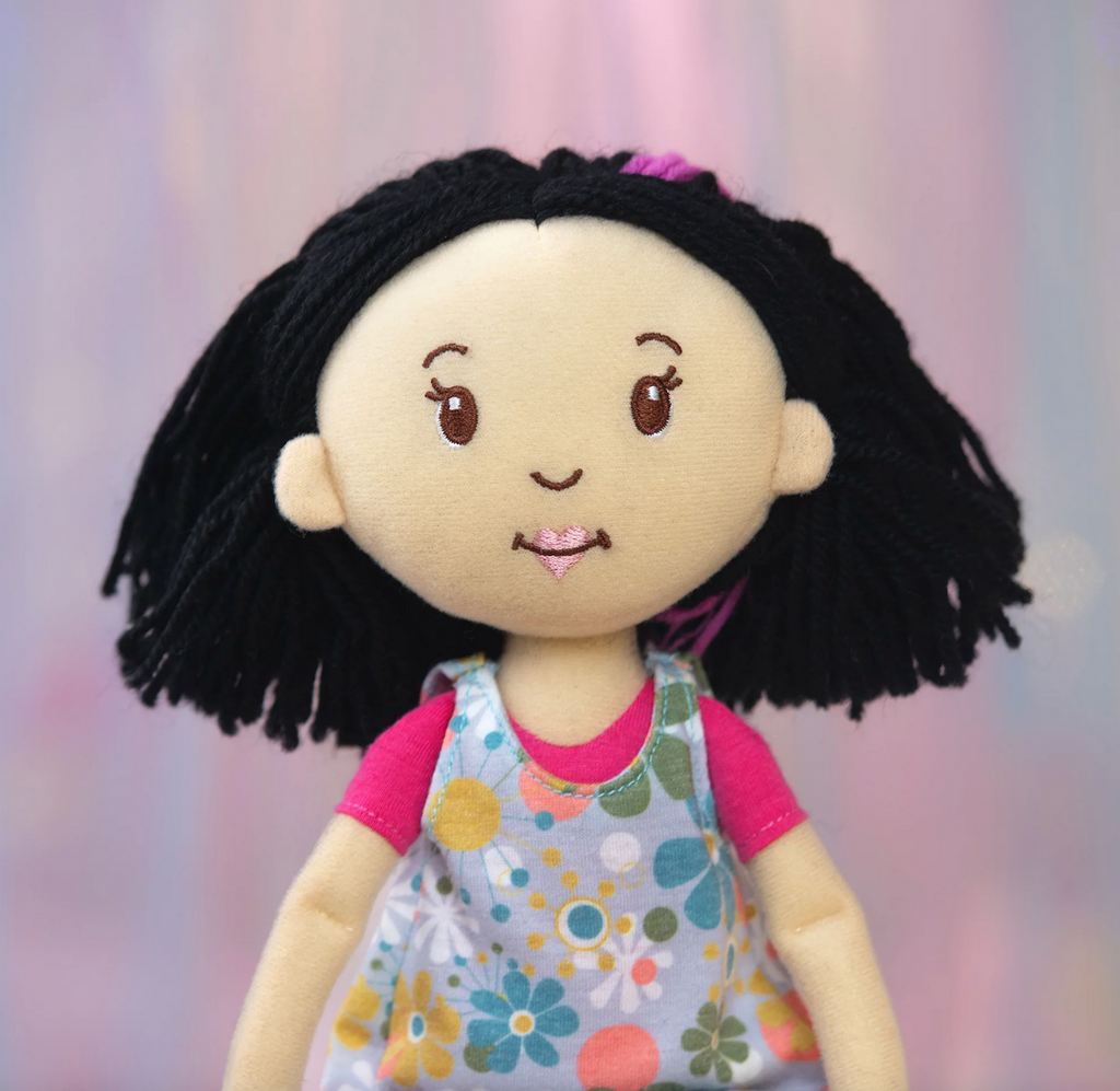 Close up of Groovy Girls doll Daisy with black hair and a lovely smile. 