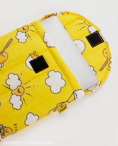 The puffy lap top sleeve with Gudetama print opened to show the velcro closure. 