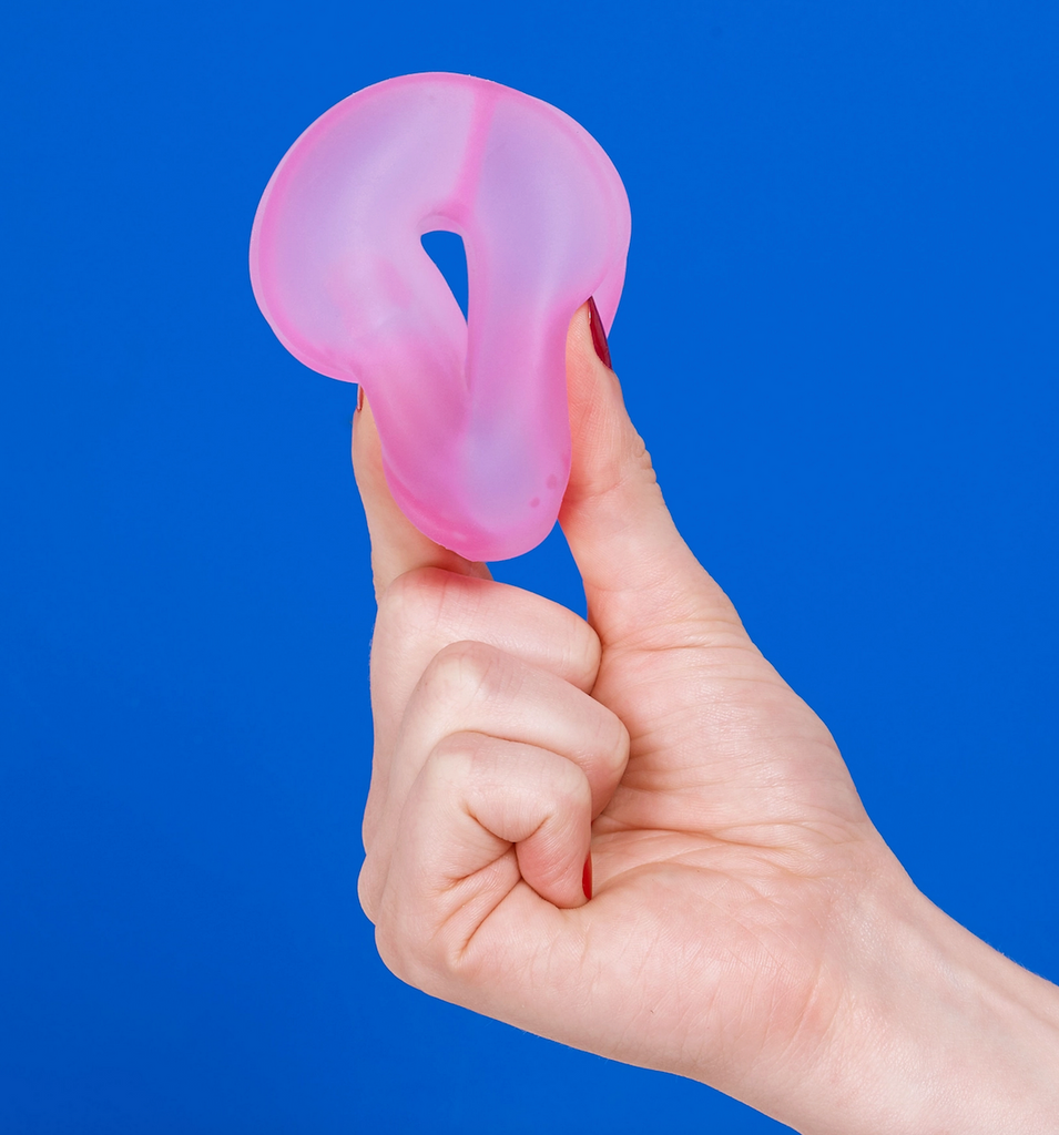 Gump Loop in Moon Jelly being squished between a thumb and forefinger. 
