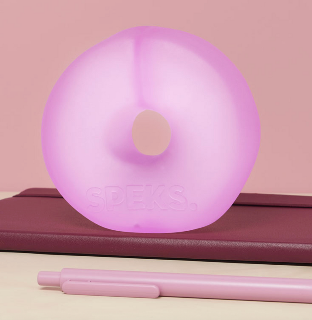 Jumbo sized Gump Loop stress toy sitting on a desktop. 