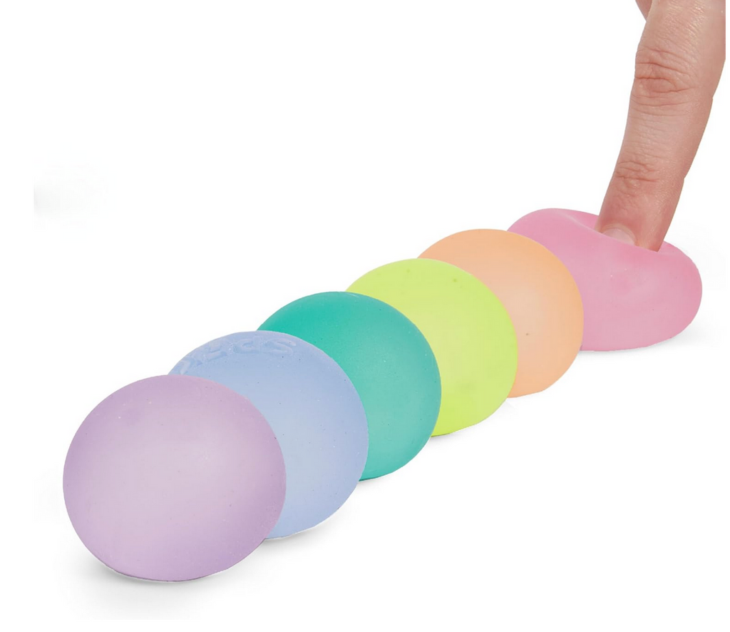 Each of the Gimp minis stress balls lined up with the last one being squeezed by a finger. The colors are dew, sea glass, mist, reef, algae, and moon 