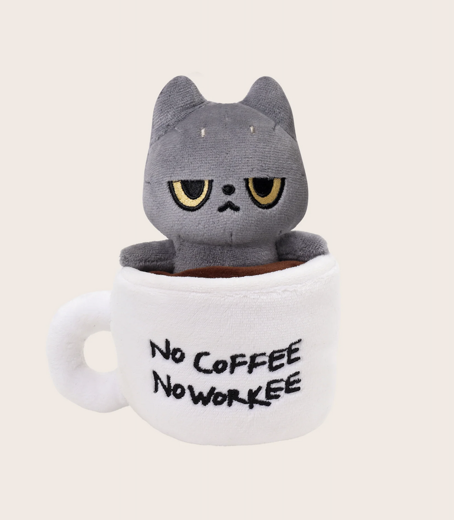 Plush, grey cat sitting in a white cup of coffee that reads "No Coffee No Workee"