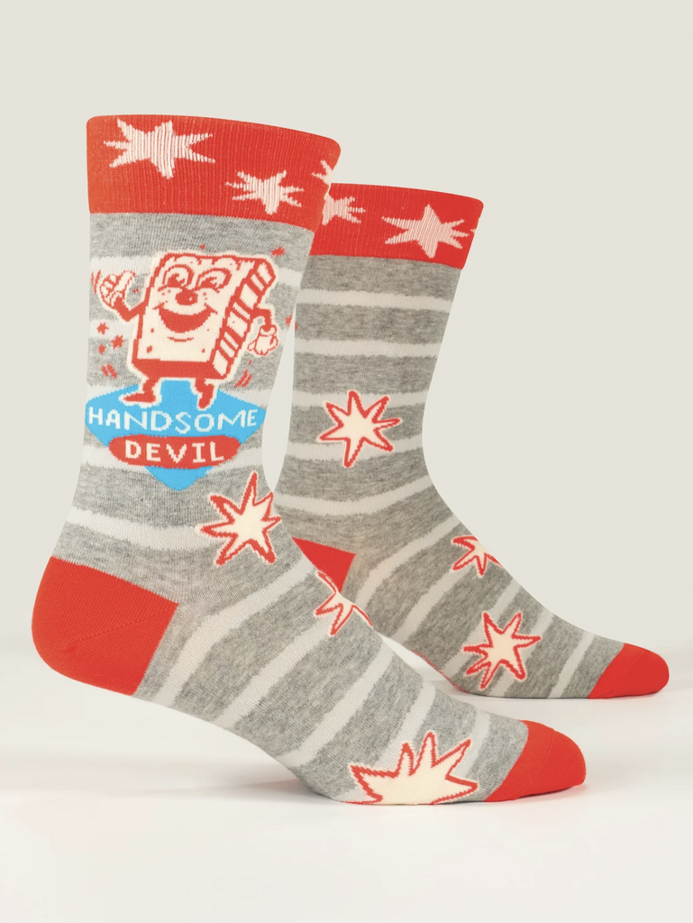 Grey socks with white stripes and red toes, heel and top that read "Handsome Devil" 