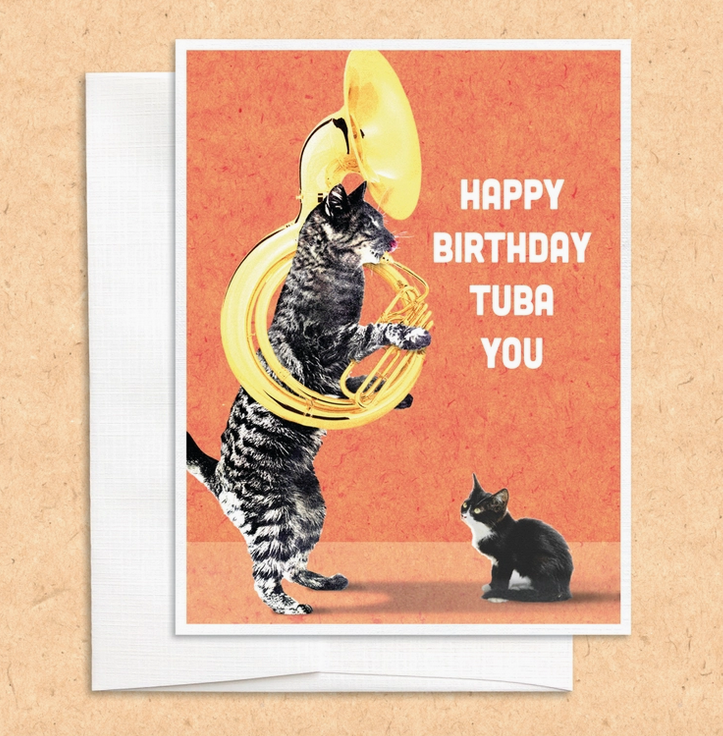 Greeting card illustrated with a cat playing a tuba to a kitten that reads "Happy Birthday Tuba you"