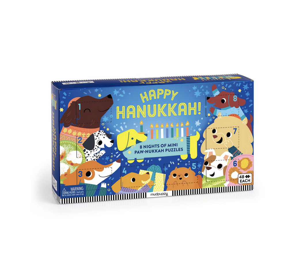 Box cover for the Happy Hanukkah 8n Nights of Mini Puzzles. With perforated windows to open each night of Hanukkah that reveals a mini 48 piece puzzle. Illustrated with cheerful dogs celebrating the holiday season. 