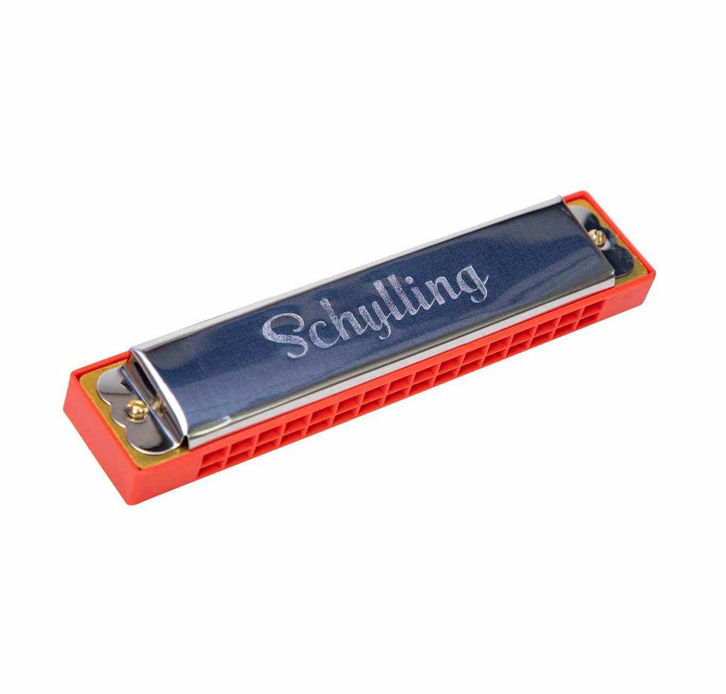 Tin red harmonica on a white background.