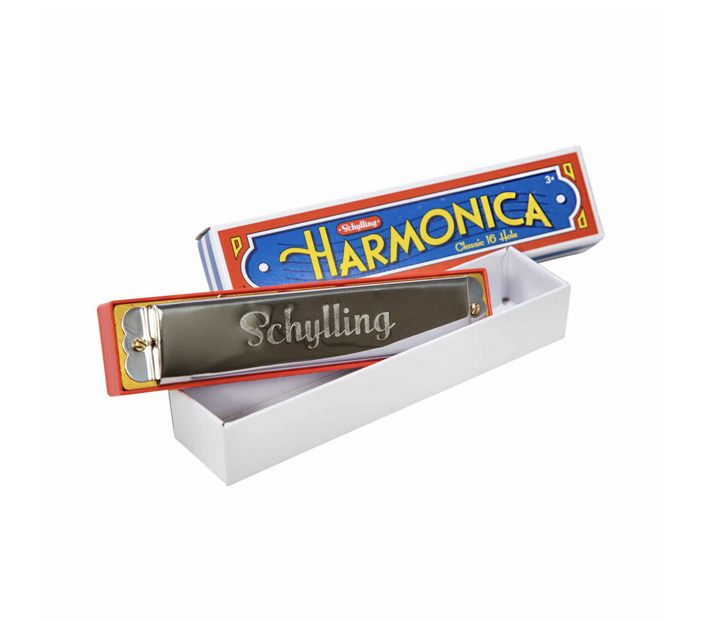 Tin harmonica in box.