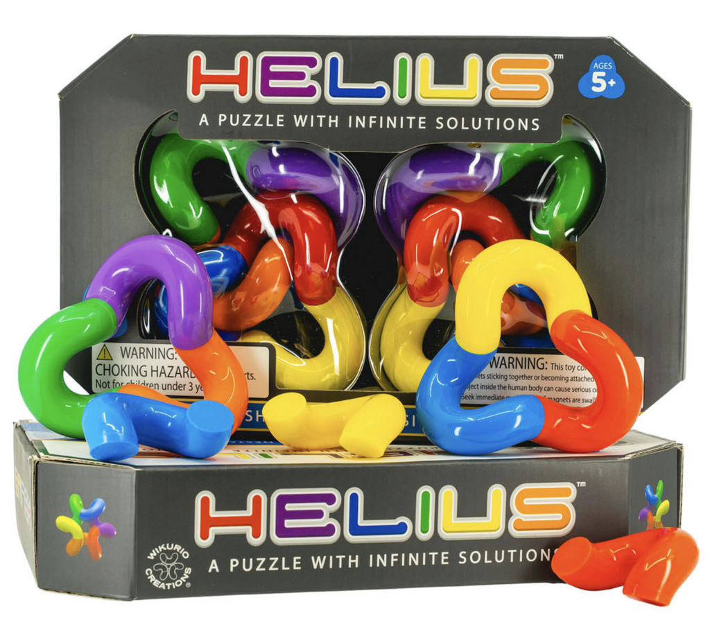 Helius Puzzle packaged in a black box with a clear window at the front that shows off he brightly colored magnetic puzzle shapes. 