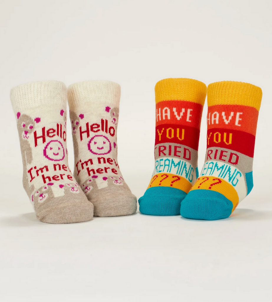 "Hello I'm New Here" and "Have You Tried Screaming?" baby socks displayed on mannequin feet. 