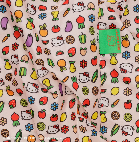 Close up of the Hello Kitty Icons pattern. It is a pale pink with Hello Kitty faces, strawberries, lemons, flowers, and various other fruits and vegetables. 
