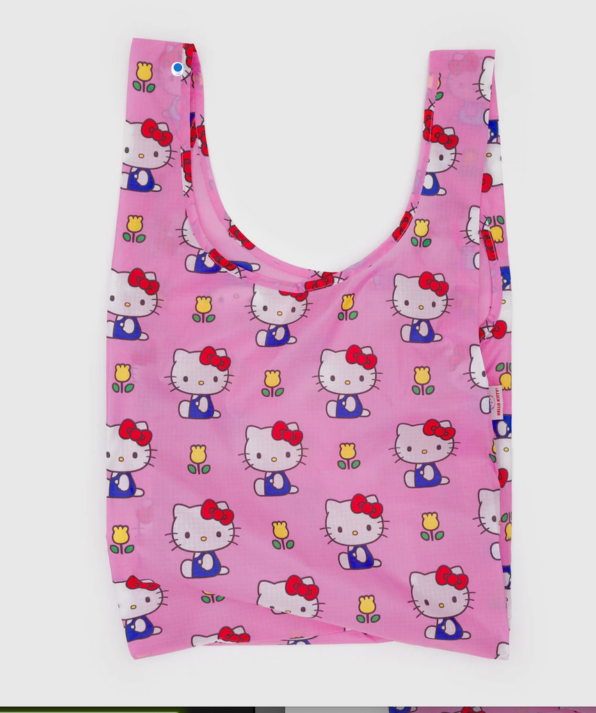 Pink reusable bag with Hello Kitty wearing her blue overalls and wearing a red bow. 