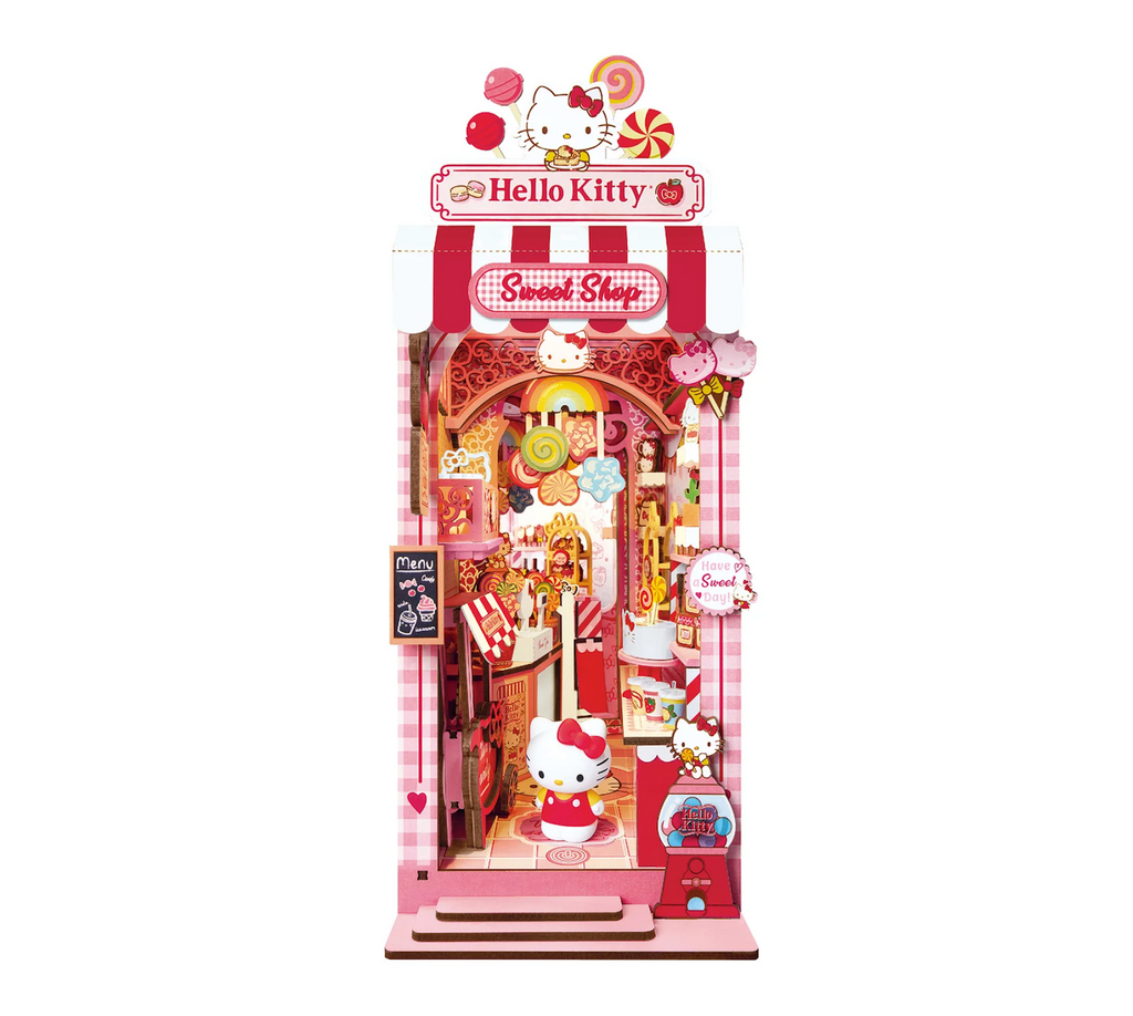 The Hello Kitty Sweet Shop Miniature Book Nook Kit fully built to show a Hello Kitty-themed sweet shop with lots of sweet treats and a beautiful lollipop chandelier hanging from the ceiling. 