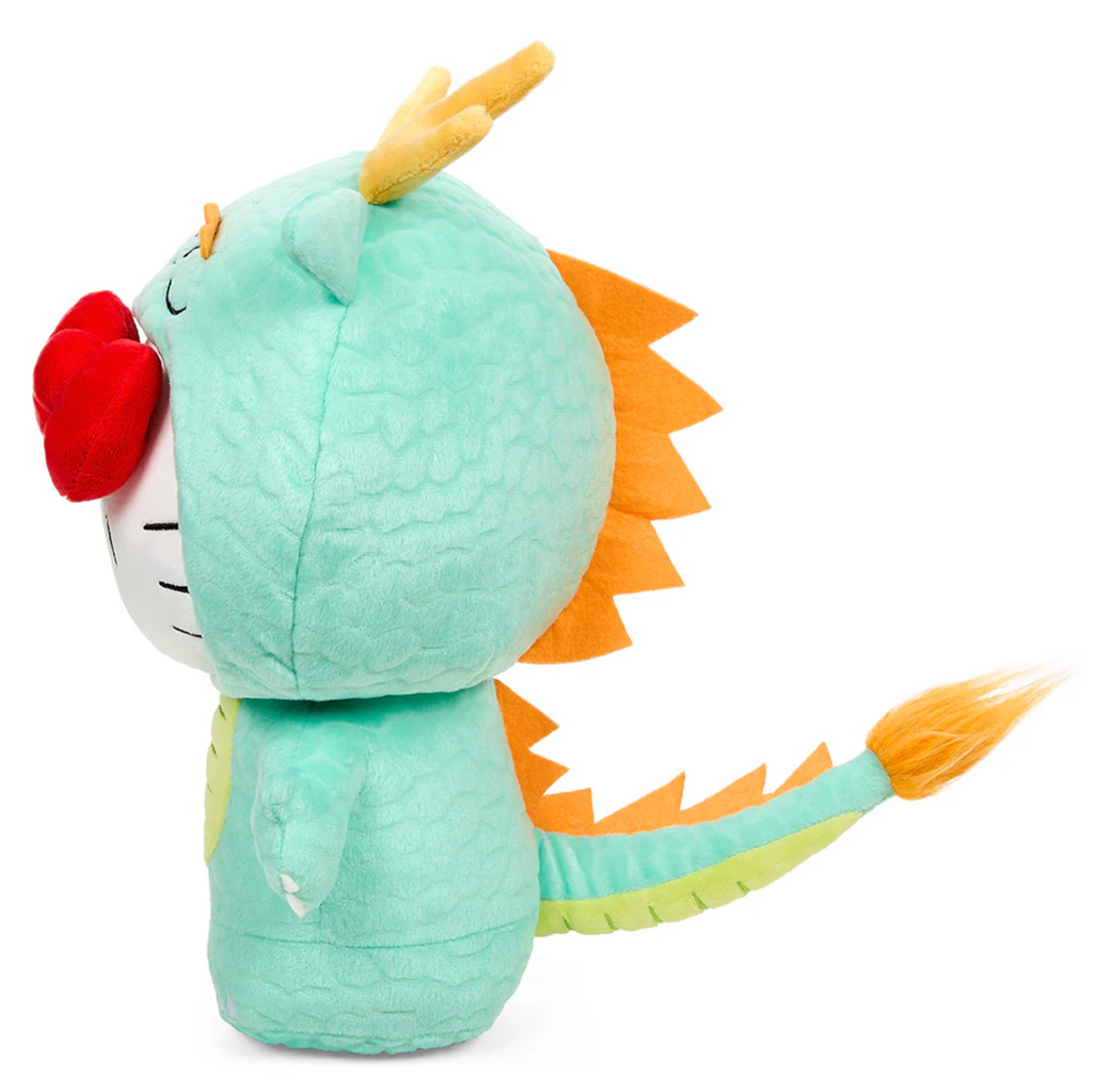 Side view of standing hello kitty plush wearing a green dragon costume with long tail that has gold spikes down the back of her head to the tip of her tail.