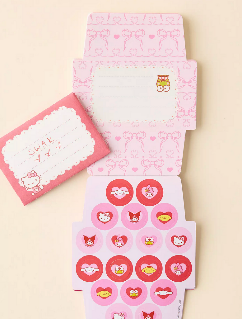 The Hello Kitty and Friends Hearts and Ribbons Mini Valentine pad opened to the page with round stickers of each of the characters featured throughout the notepad. 